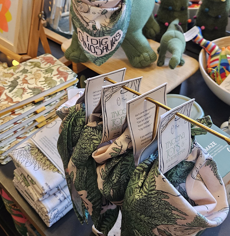 Manchester Museum Souvenir shop supplier, printed textiles, gifts for cultural institutions, wholesale orders. Triceratops and ferns collections, dinosaur merch.