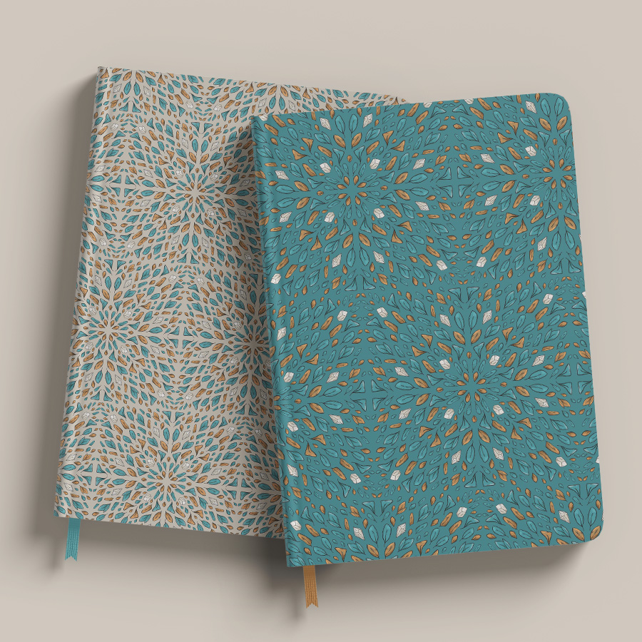 illustration pattern on cream and teal background of orange and teal leaves arranged on squares then forming tiles with some tiny white crystals in between. pattern applied on mockup of two notepads, top view.