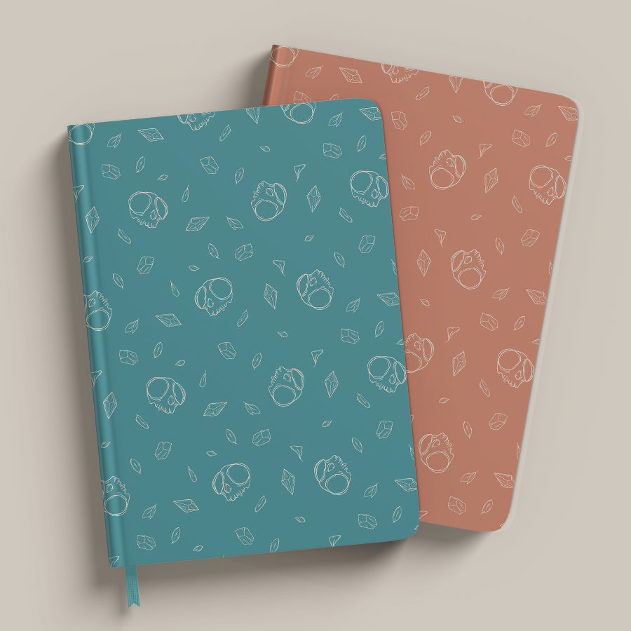 illustration pattern on teal background of white outline of tiny skull, leaves and tiny crystals scattered loosely and clean. pattern applied on notepads mockups.
