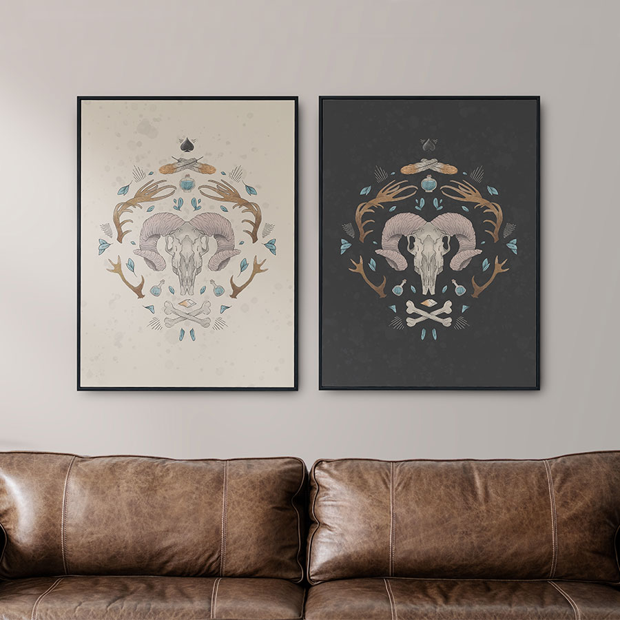 illustration of hero print on cream background of bison skull motif, horns mirrored, potion pots, floating teal leaves, crossed feathers, crossed bones, spades suit playing cards icon symbol. prints applied on mockup of frames hanging on wall in living room, dark brown leather sofa.
