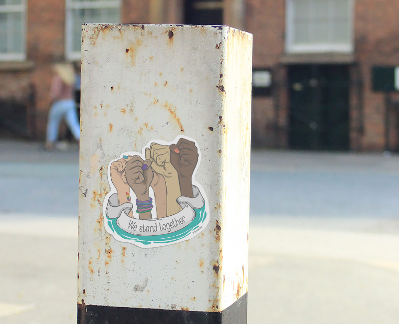 Activist sticker hands up fists in the air feminist theme different skin colours tones. Femeestick.