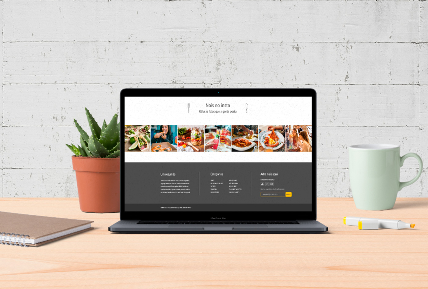 website on computer mockup at cafe table, plant and mug close.