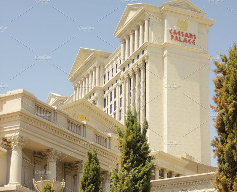 Las Vegas casino, Caesars Palace, famous greek themed building, towers and trees surround it.