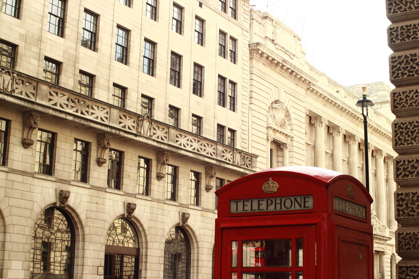 Outside of building in London, vintage architecture, classic british telephone booth on the corner. Photo sold on Creative Market.